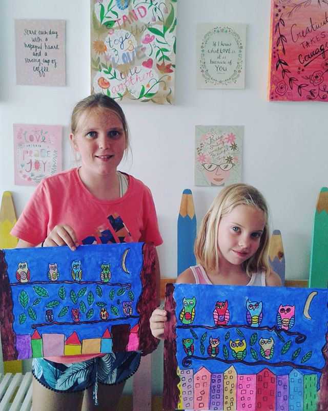 Kids holding matching owl artwork